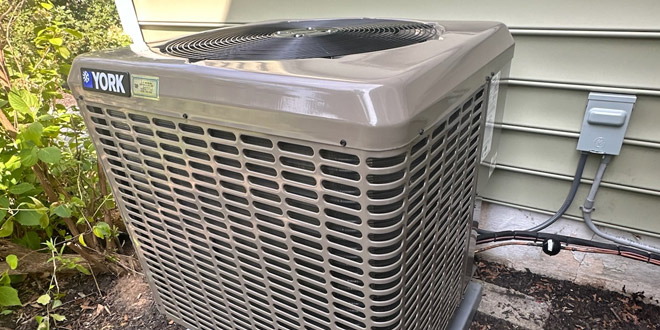 JR Michalski HVAC technician diagnosing an AC system in Bucks County PA